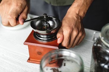 person holding round silver equipment