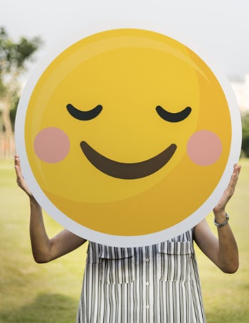 Person Holding Round Smiling Emoji Board Photo