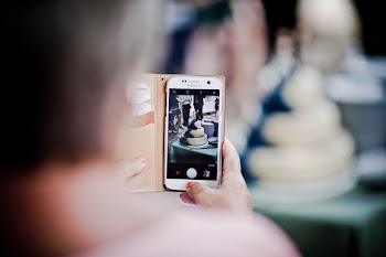 Person Holding Samsung Galaxy S7 Displaying 3-tier Cake