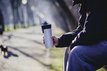 Person Holding Silver Tumbler