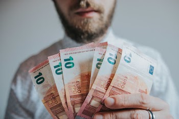 Person Holding Six 10 Banknotes
