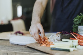 Person Holding Sliced of Carrots