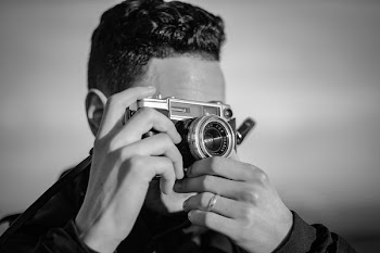 person holding SLR camera