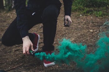 person holding smoke can