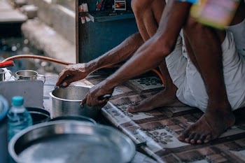 person holding stainless steel cooking pot