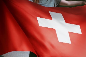 Person holding Switzerland flag background, | Free Photo - rawpixel