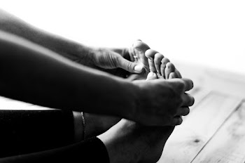 Person Holding Their Feet