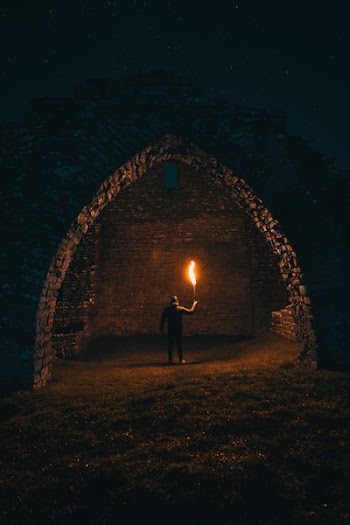 person holding torch in building interior