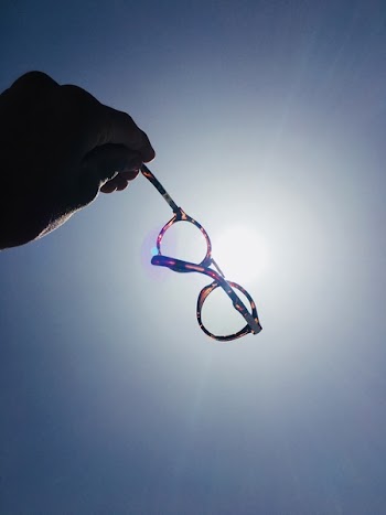 Person Holding Tortoiseshell Framed Eyeglasses