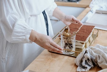 Person Holding Tray With Food and Stainless Steel Fork and Spoons