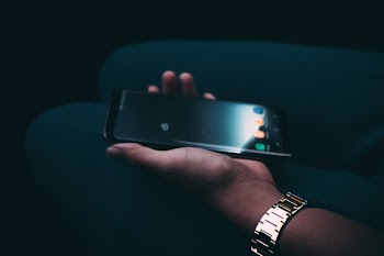 Person Holding Turned-on Black Android Smartphone