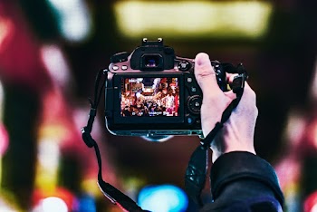 Person Holding Turned-on Camera
