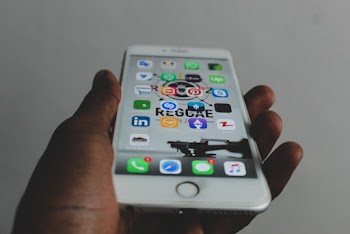 Person Holding Turned-on Silver Iphone 