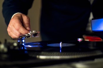 Person Holding Vinyl Player in Shallow Focus Photography