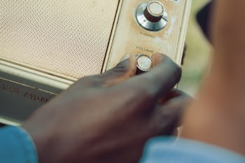 Person Holding Volume Knob