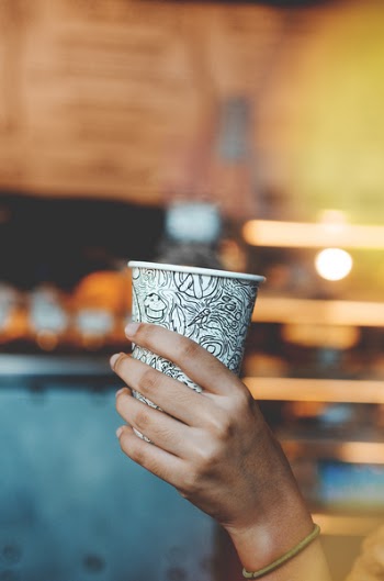 Person Holding White And Black Coffee Cup