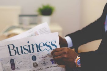 Person Holding White and Blue Business Paper
