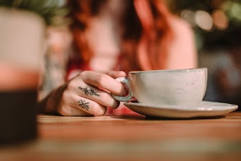 Person Holding White Ceramic Cup