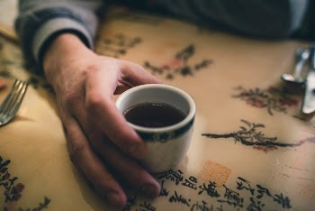 Person Holding White Ceramic Mug
