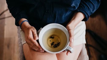 person holding white ceramic mug