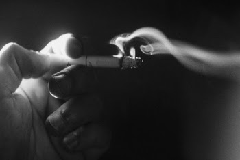Person Holding White Cigarette Stick