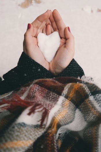 Person Holding White Heart Decor
