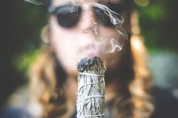 person holding white incense