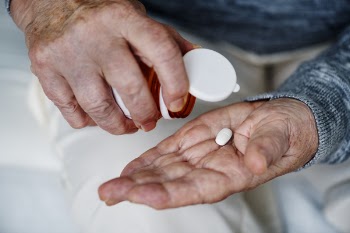 Person Holding White Medication Tablet