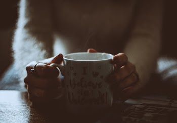 Person Holding White Mug
