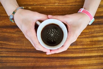 Person Holding White Mug