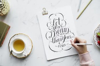 Person Holding White Pen Near White Poster
