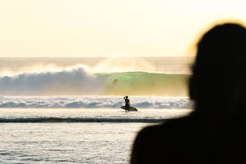 person holding white surfboard
