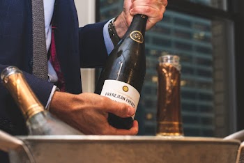 Person Holding Wine Bottle