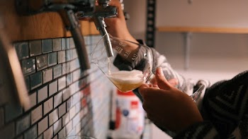 Person Holding Wine Glass Refilling Soda