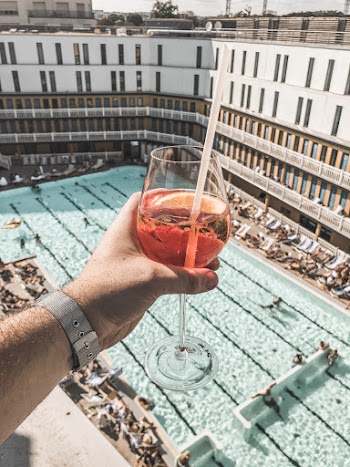 Person Holding Wine Glass With White Straw and Drink