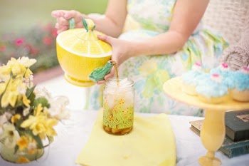 Person Holding Yellow and Green Lime Shape Ceramic Tea Pot