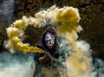 Person Holding Yellow Smoke