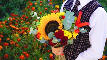 Person Holding Yellow Sunflower Bouquet