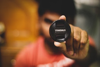 Person Holding Yongnuo Lens Tip