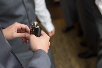 Person Holds Black Hip Flask