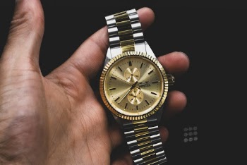 Person Holds Gold Colored Invicta Analog Watch 