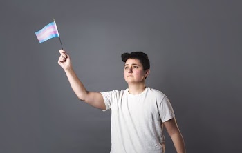Person Holds Up Trans Pride Flag