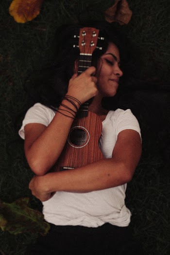 Person Hugging Brown Ukelele