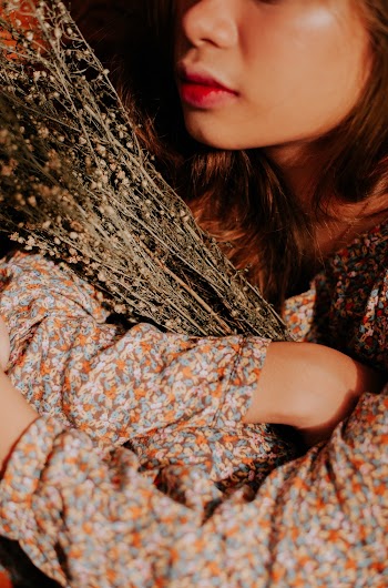 Person Hugging Bunch of Flowers