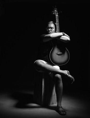 Person Hugging Guitar