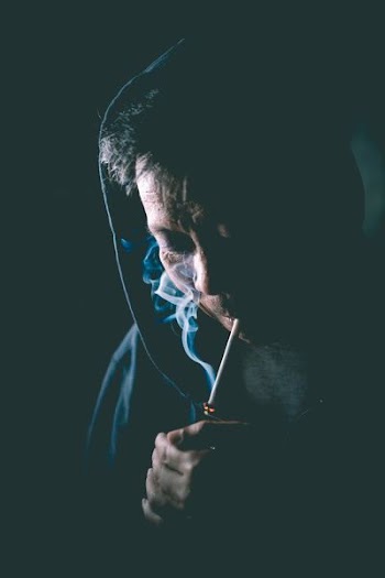 person igniting cigarette