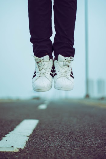 Person in Adidas Sneakers