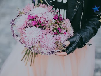 Person in Black Leather Jacket Pink and Red Flower Bouquet