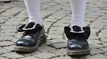 Person in Black Leather Shoes