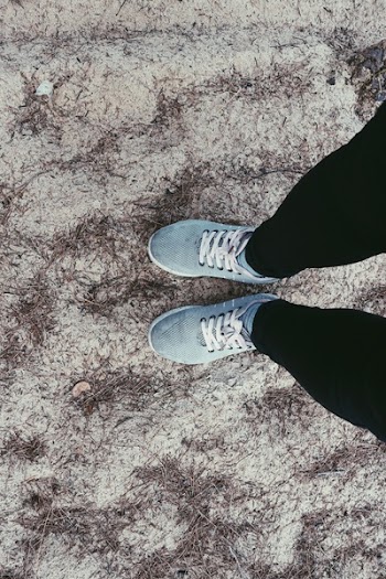 Person in Black Pants and Pair of Blue Sneakers